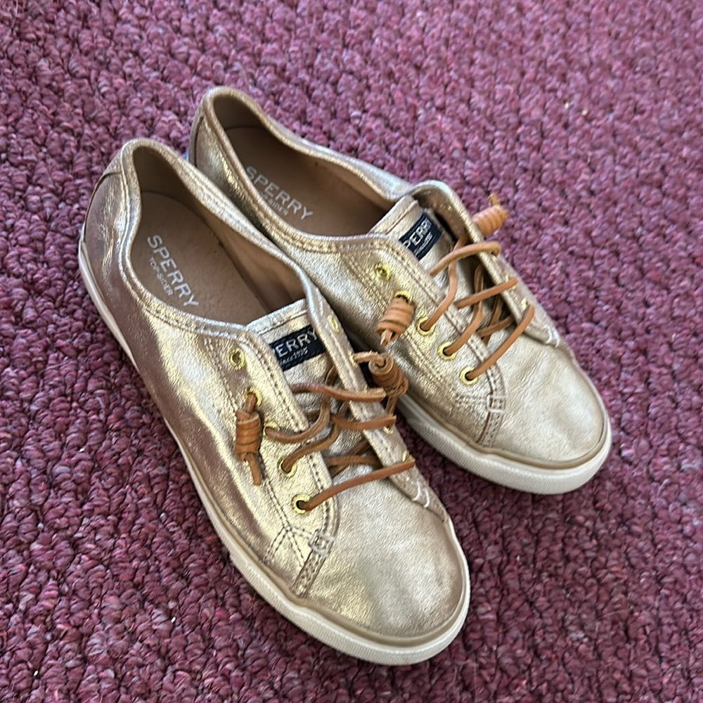 Gold Sperry slip on sneakers